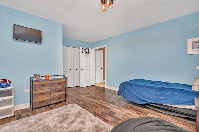 bedroom featuring a closet and dark wood-type flooring