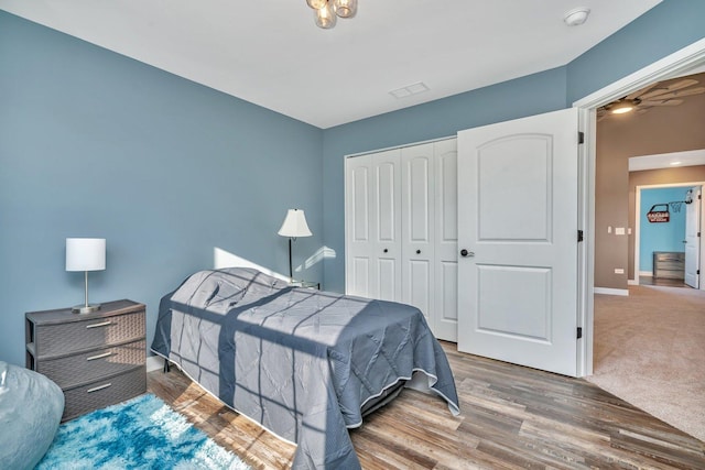 bedroom with a closet and dark wood-type flooring