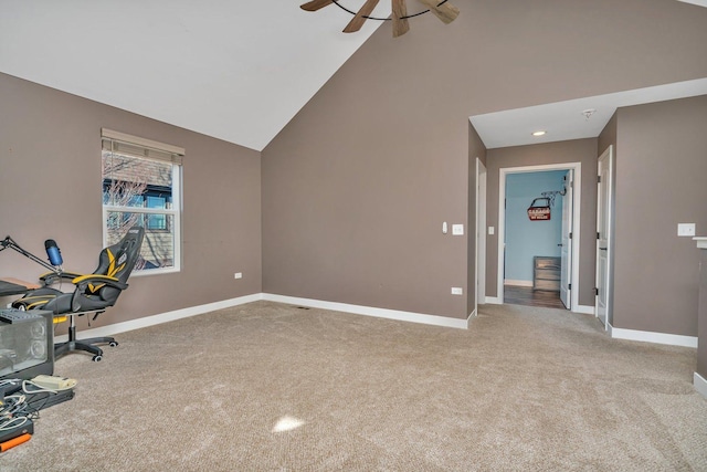 unfurnished office with ceiling fan, light colored carpet, and high vaulted ceiling