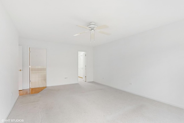 empty room with light colored carpet and ceiling fan