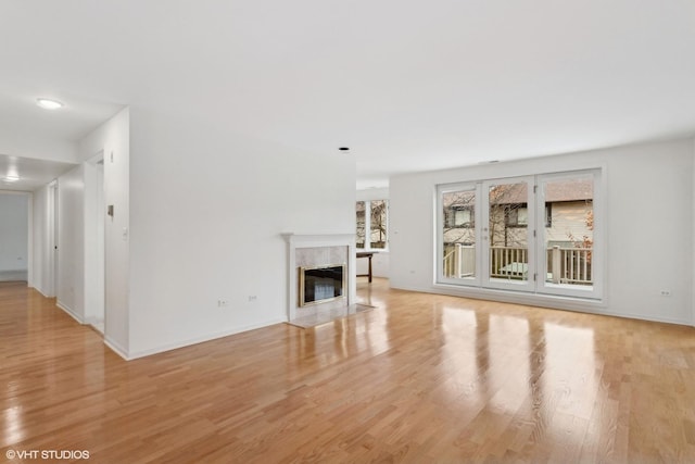 unfurnished living room featuring a fireplace and light hardwood / wood-style flooring