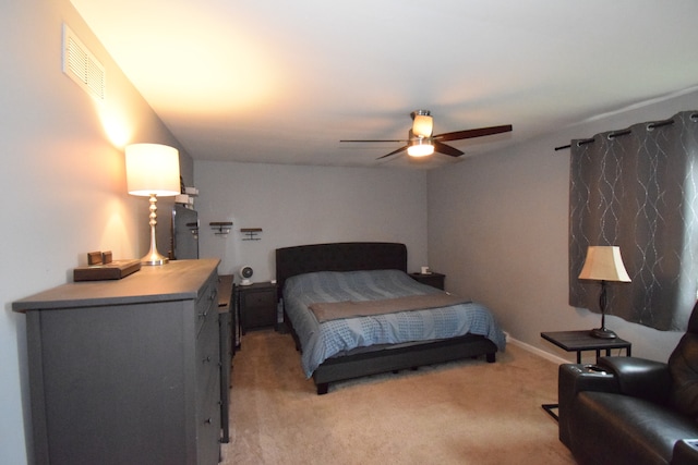 bedroom featuring ceiling fan and light carpet