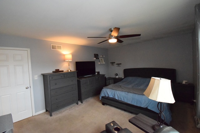 bedroom featuring ceiling fan and light carpet