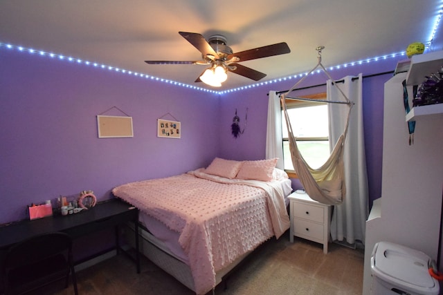 bedroom featuring dark colored carpet and ceiling fan