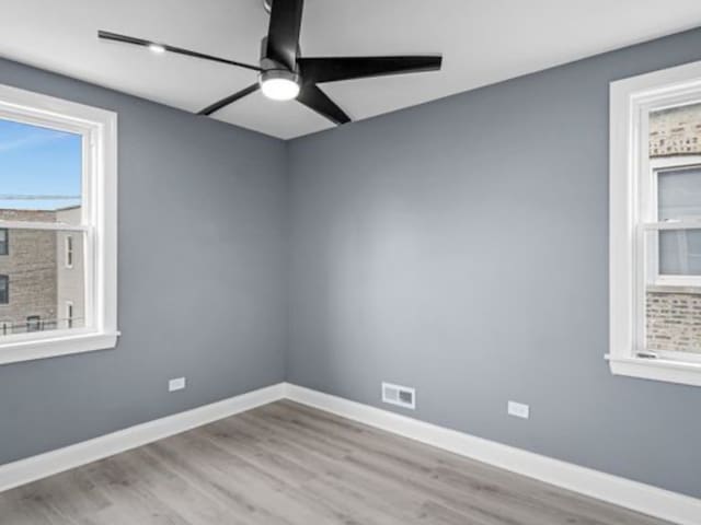 unfurnished room featuring light hardwood / wood-style flooring and ceiling fan