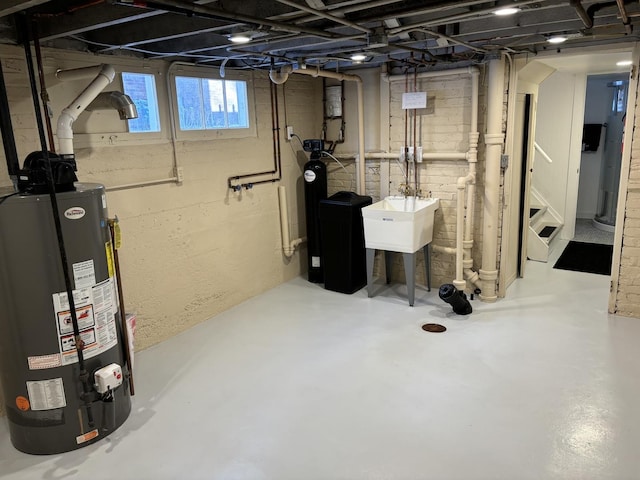 basement with gas water heater and sink