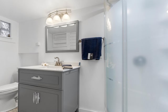 bathroom featuring a shower, vanity, and toilet