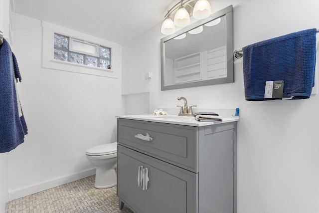 bathroom featuring toilet, vanity, and tile patterned floors