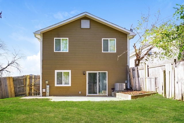 back of property with a yard, cooling unit, and a patio area