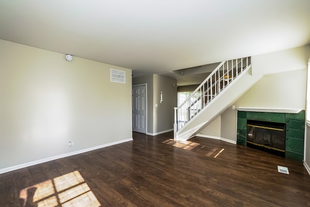 unfurnished living room with dark hardwood / wood-style floors and a fireplace