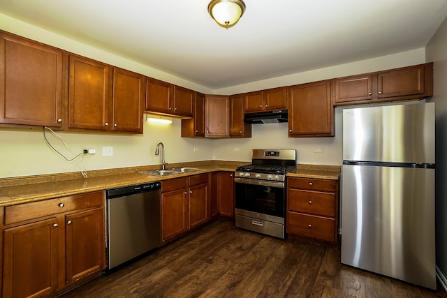 kitchen featuring stainless steel appliances, dark wood-type flooring, and sink