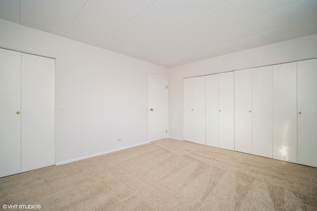 unfurnished bedroom with light colored carpet