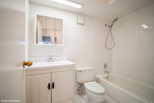 full bathroom with tile patterned floors, vanity, toilet, and tiled shower / bath combo