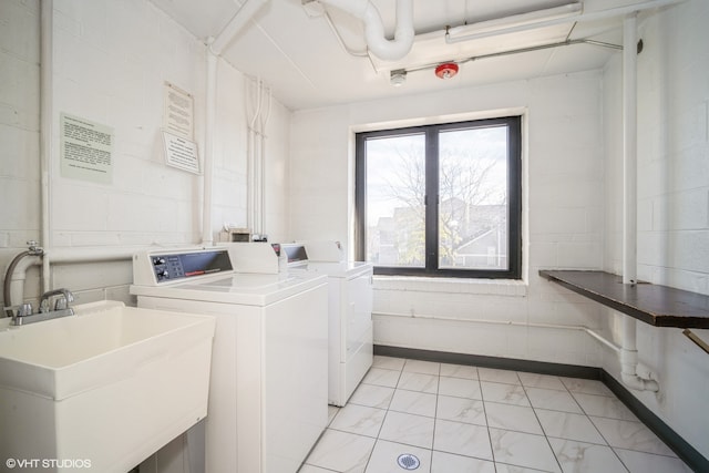 laundry area featuring sink and washing machine and clothes dryer