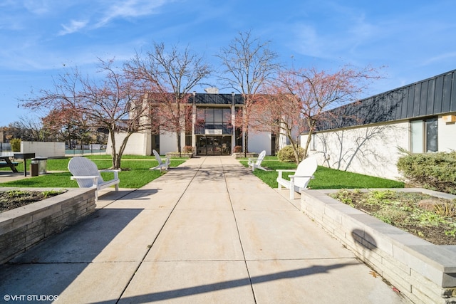 view of front of house with a patio and a front lawn