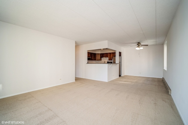 unfurnished living room featuring carpet flooring, a textured ceiling, baseboard heating, and ceiling fan