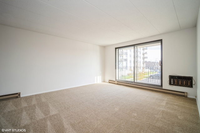 carpeted spare room featuring baseboard heating