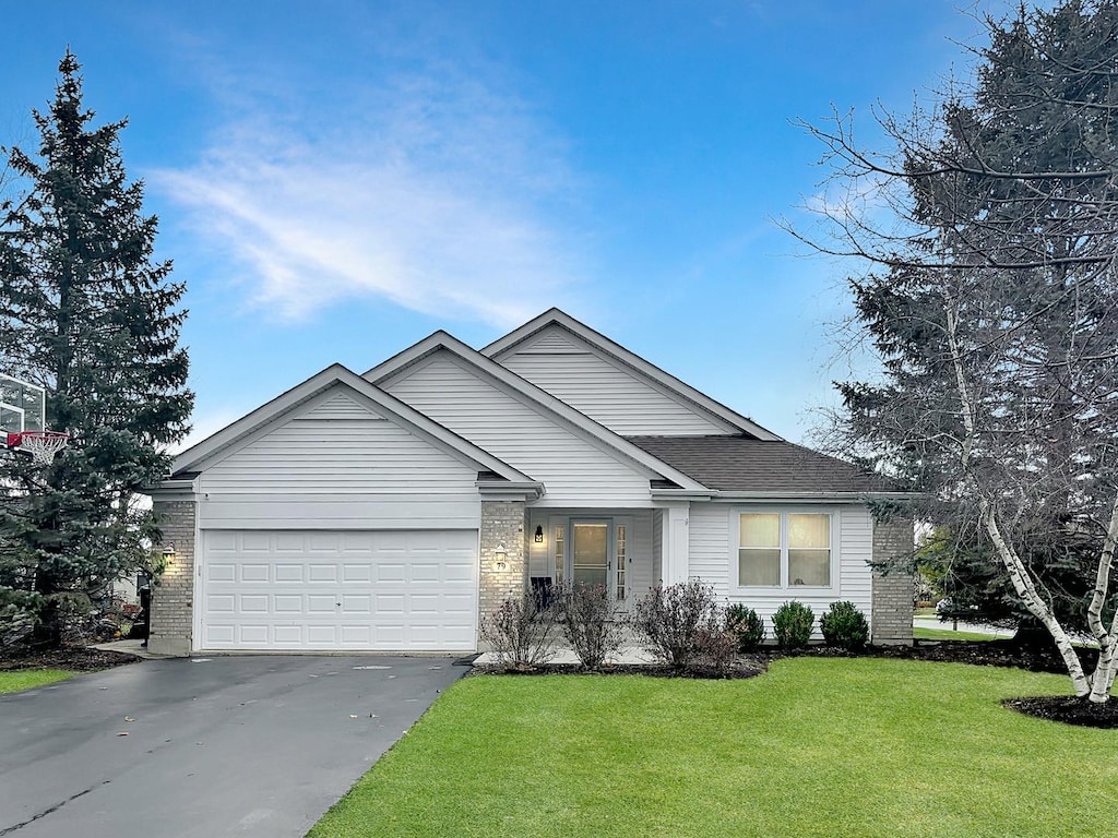 view of front of property with a front lawn and a garage