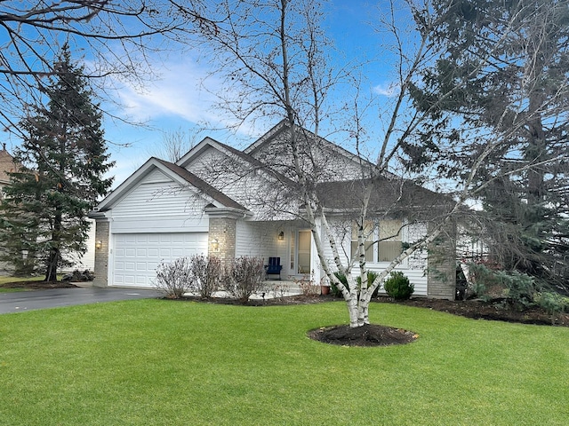 view of front of property with a front lawn and a garage