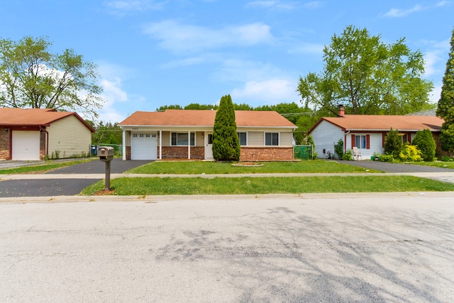 ranch-style home featuring a front lawn and a garage