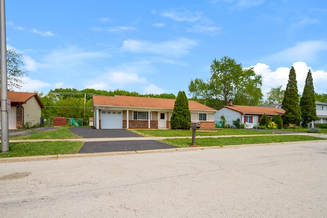 ranch-style house with a garage and a front lawn