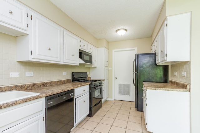 kitchen featuring light tile patterned floors, backsplash, white cabinetry, and black appliances