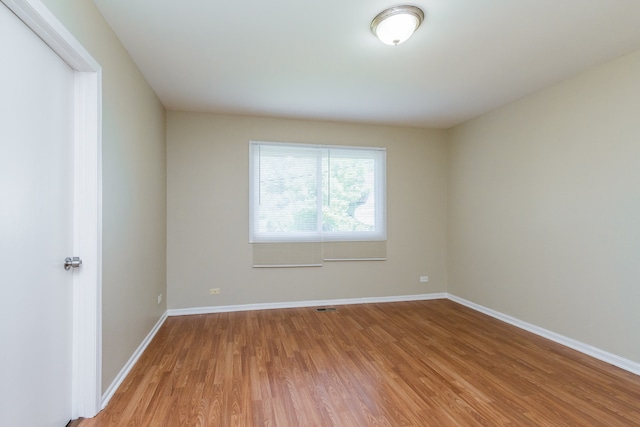 spare room featuring hardwood / wood-style floors