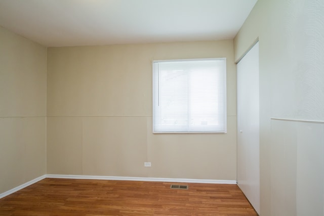 spare room featuring hardwood / wood-style floors