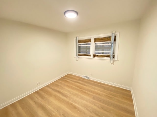 unfurnished room with hardwood / wood-style floors