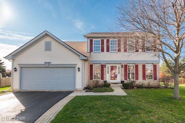 view of front of house featuring a garage and a front lawn