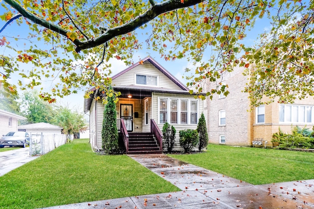 bungalow-style home with a front lawn