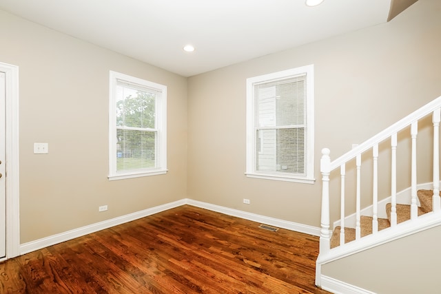 empty room with hardwood / wood-style flooring