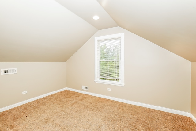 bonus room with carpet floors and vaulted ceiling