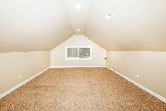 bonus room featuring lofted ceiling and carpet floors