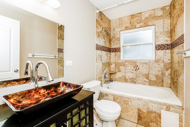 full bathroom with vanity, tiled shower / bath combo, and toilet