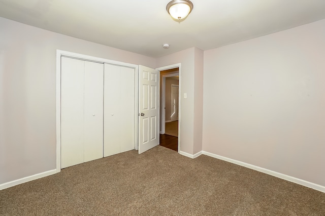 unfurnished bedroom with carpet flooring and a closet