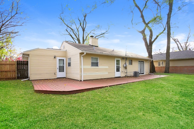 back of house with a yard, a deck, and central AC unit