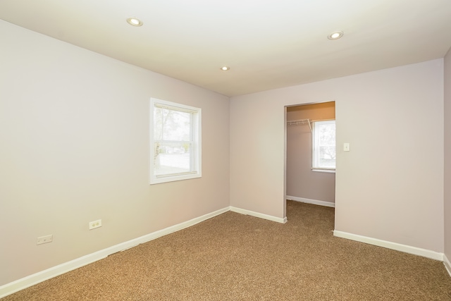 carpeted empty room featuring plenty of natural light