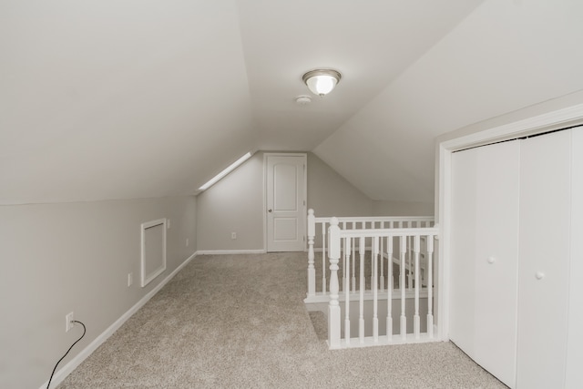 bonus room featuring light carpet and vaulted ceiling