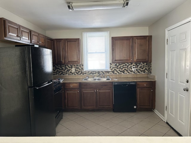 kitchen featuring black appliances, dark brown cabinets, a sink, and light countertops