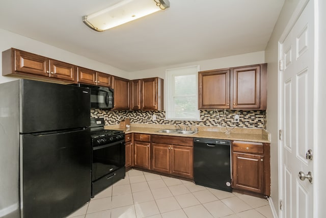 kitchen with black appliances, light tile patterned flooring, sink, and tasteful backsplash