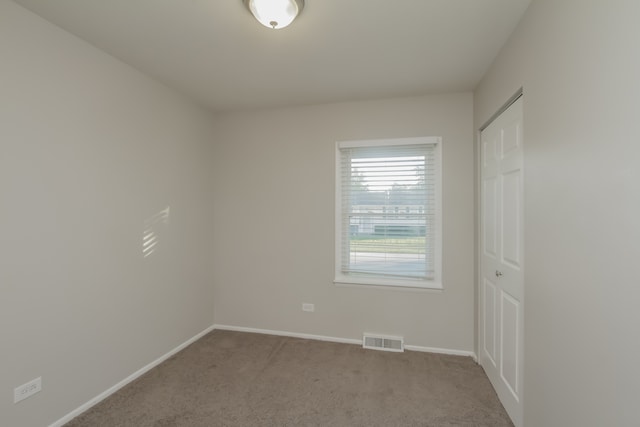 unfurnished room with light colored carpet