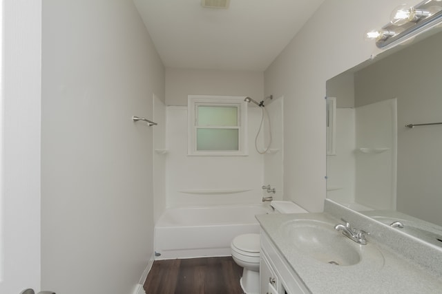 full bathroom featuring hardwood / wood-style flooring, vanity,  shower combination, and toilet