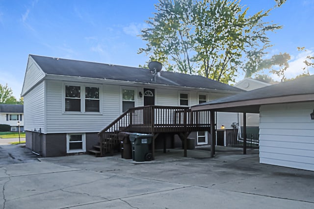 rear view of property with a wooden deck