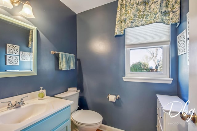 bathroom featuring vanity and toilet