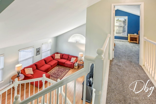 carpeted living room featuring lofted ceiling