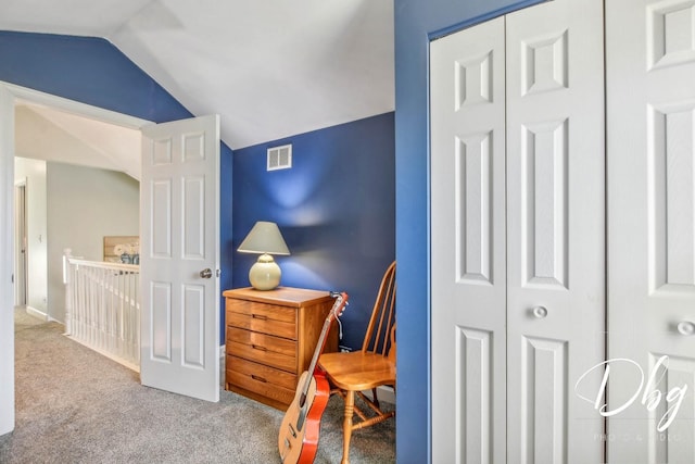 carpeted bedroom with lofted ceiling and a closet