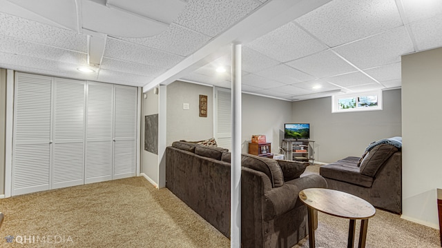 carpeted living room featuring a paneled ceiling