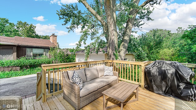 deck with outdoor lounge area and a grill