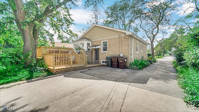 rear view of house with a wooden deck